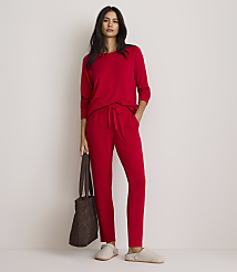 A woman in red pajamas stands with a brown tote bag and slippers against a plain white background. carousel Product Image 1