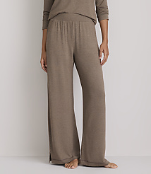 A person stands in loose-fitting brown lounge pants and a matching top against a plain white background. carousel Product Image 2