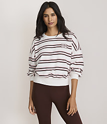 A woman in a striped sweatshirt and brown leggings stands against a plain, light-colored background. carousel Product Image 2