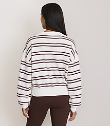 A woman in a striped sweater and brown leggings stands against a plain white background. carousel Product Image 3