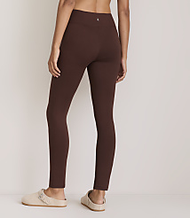 A person wearing brown leggings and clogs stands against a plain, light-colored background. carousel Product Image 3