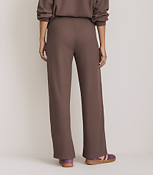 A person wearing brown ribbed pants and purple sneakers stands against a plain, light-colored background. carousel Product Image 3