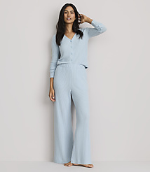 A woman in light blue ribbed pajamas stands against a plain, light gray background. carousel Product Image 1
