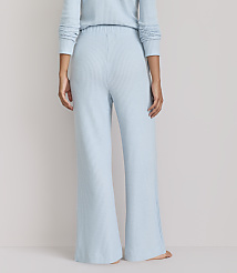 A person stands in light blue waffle-knit pajamas against a plain, light gray background. carousel Product Image 3