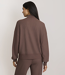A woman in a brown ribbed sweatshirt and pants stands against a plain, light brown background. carousel Product Image 3