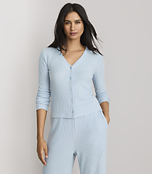 A woman in a light blue ribbed cardigan and matching pants stands against a plain white background. carousel Product Image 2