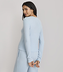 A woman in a light blue ribbed top and pants stands against a plain gray background. carousel Product Image 3
