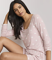 A woman in a pink polka dot pajama set poses against a plain white background. carousel Product Image 2