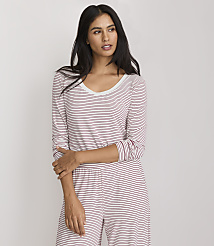 A woman in a striped pajama set stands against a plain white background. carousel Product Image 1