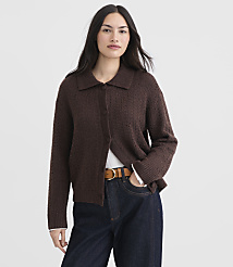 A woman in a brown cardigan and jeans stands against a plain white background. carousel Product Image 1