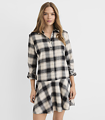 A woman in a plaid shirt dress stands against a plain white background. carousel Product Image 1