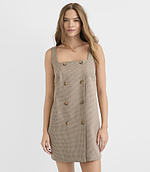 A young woman in a plaid dress stands against a plain white background. carousel Product Image 1