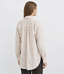 A woman in a light pink plaid shirt stands against a plain white background. carousel Product Image 3