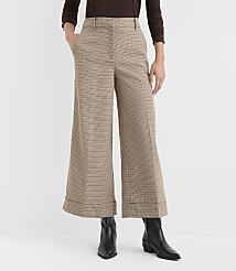 A person stands in wide-leg, checkered pants and black boots against a plain white background. carousel Product Image 2
