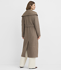 A woman in a long, brown belted coat stands against a plain white background. carousel Product Image 3