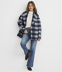 A woman in a plaid coat and jeans stands against a plain white background. carousel Product Image 2