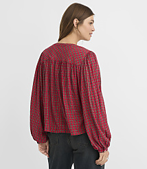 A woman in a red plaid blouse stands against a plain white background. carousel Product Image 3