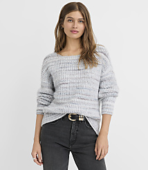 A woman in a grey striped sweater and black jeans stands against a plain grey background. carousel Product Image 2