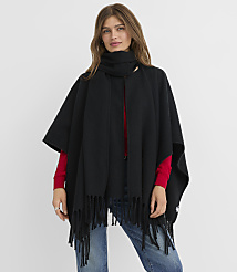 A woman in a black fringed poncho and scarf stands against a plain white background. carousel Product Image 1