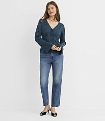 A woman in a teal patterned blouse and blue jeans stands against a plain white background. carousel Product Image 3