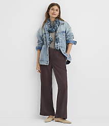 A woman in a denim jacket and wide-leg pants stands against a plain white background. carousel Product Image 1