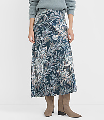 A woman in a teal paisley skirt and taupe boots stands against a plain white background. carousel Product Image 2