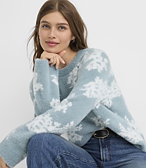 A woman in a fuzzy blue snowflake sweater and jeans poses against a plain white background. carousel Product Image 1