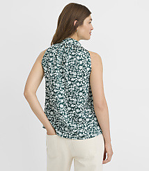 A woman in a floral top and jeans stands against a plain white background. carousel Product Image 3