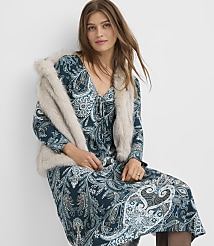A woman in a teal paisley dress and a faux fur stole poses against a plain white background. carousel Product Image 1