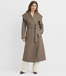 A woman in a long, brown, belted coat stands against a plain white background. carousel Product Image 2