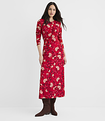 A woman in a red floral dress and brown boots stands against a plain white background. carousel Product Image 2