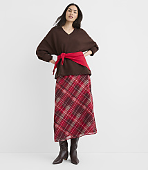 A woman in a brown v-neck sweater and a red plaid skirt stands against a plain white background. carousel Product Image 2