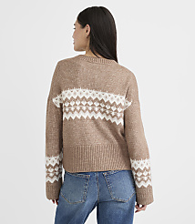 A woman in a tan and white patterned sweater and blue jeans stands against a plain white background. carousel Product Image 3