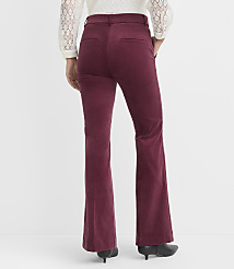 A person wearing burgundy corduroy flare pants and a white lace-trimmed top stands against a plain white background. carousel Product Image 4