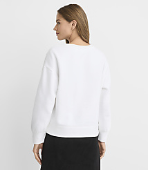 A woman in a white sweatshirt and black skirt stands against a plain white background. carousel Product Image 3
