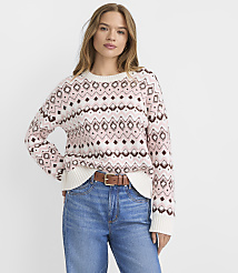 A woman in a patterned sweater and jeans stands against a plain white background. carousel Product Image 1