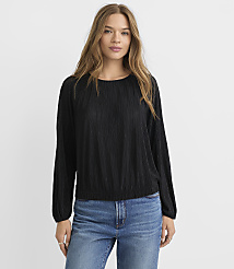 A woman in a black textured long-sleeved shirt and blue jeans stands against a plain white background. carousel Product Image 2