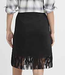 A person wearing a black fringed skirt and a plaid shirt stands against a plain gray background. carousel Product Image 3
