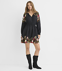 A woman in a black floral dress and black boots stands against a plain white background. carousel Product Image 2