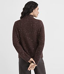 A woman in a speckled brown turtleneck sweater stands with her back to the viewer against a plain white background. carousel Product Image 4