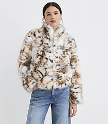 A woman in a patterned faux fur jacket and jeans stands against a plain white background. carousel Product Image 2