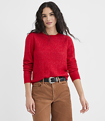 A woman in a red sweater and brown pants stands against a plain white background. carousel Product Image 1