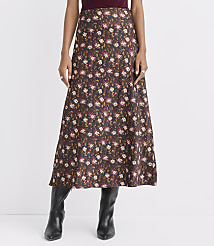 A woman in a floral midi skirt and black boots stands against a plain white background. carousel Product Image 2