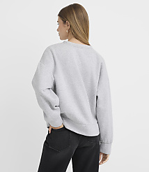 A woman in a grey sweatshirt and black jeans stands with her back to the camera against a plain white background. carousel Product Image 3