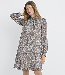 A woman in a patterned dress stands against a plain white background. carousel Product Image 2
