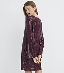 A woman in a shimmering burgundy sequined dress stands against a plain gray background. carousel Product Image 3