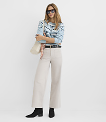 A woman in a light blue patterned sweater and cream-colored wide-leg pants stands against a plain white background. carousel Product Image 1