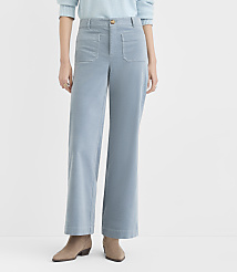 A person stands in light blue corduroy pants and tan ankle boots against a plain white background. carousel Product Image 1