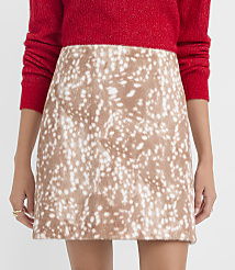 A person in a red sparkly sweater wears a tan and white spotted faux fur mini skirt against a plain white background. carousel Product Image 3