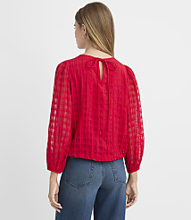 A woman in a red checkered blouse with a bow at the back stands against a plain white background. carousel Product Image 3